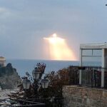 Man captures glowing figure shining through clouds