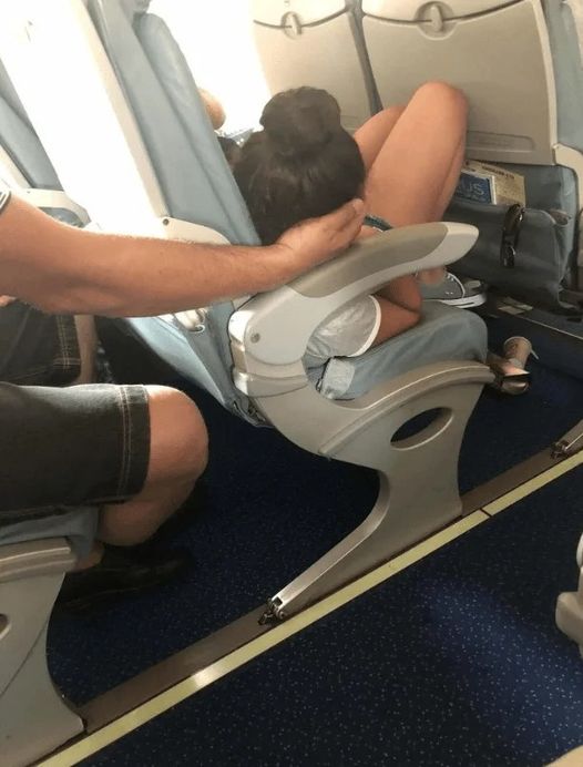 Dad sparks online debate after cradling daughter’s head for 45 minutes so she could sleep during a flight