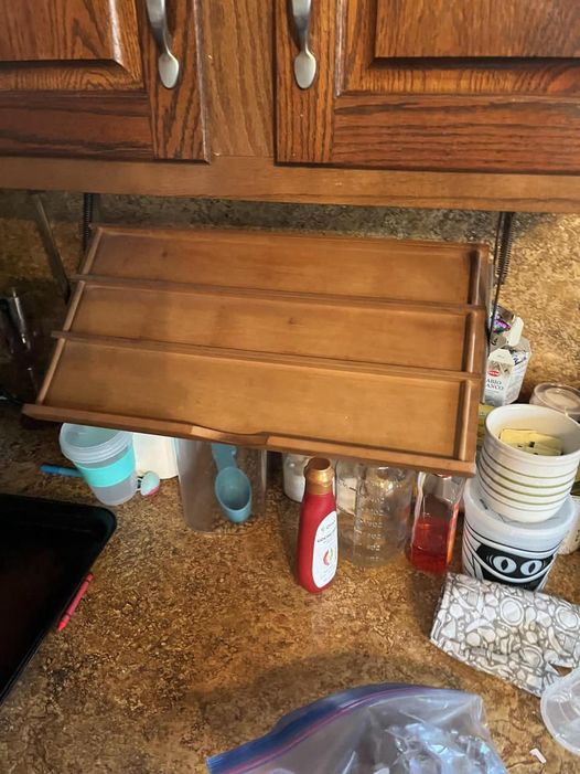 Found in kitchen of an East Coast US home. Sits flush against the bottom of cabinet when stowed, pulls down to position in the photos. What is it used for?